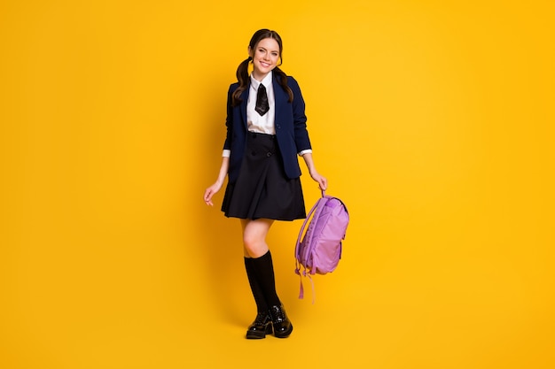 full length body size view of pretty lovely cheerful schoolgirl nerd holding bag