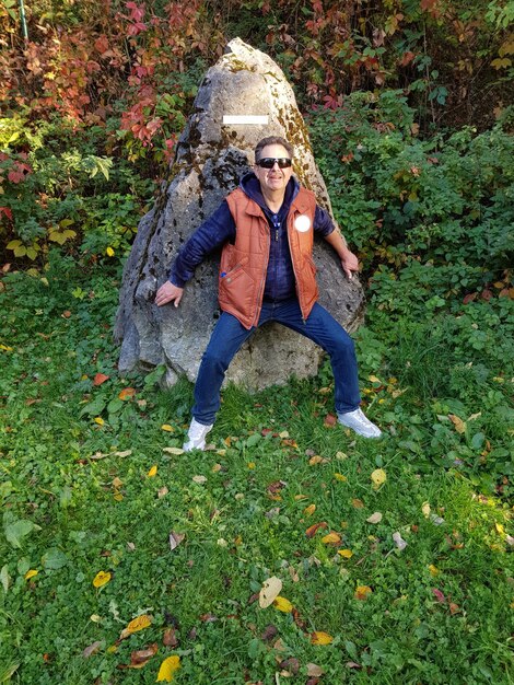 Full length of boy on plants during autumn