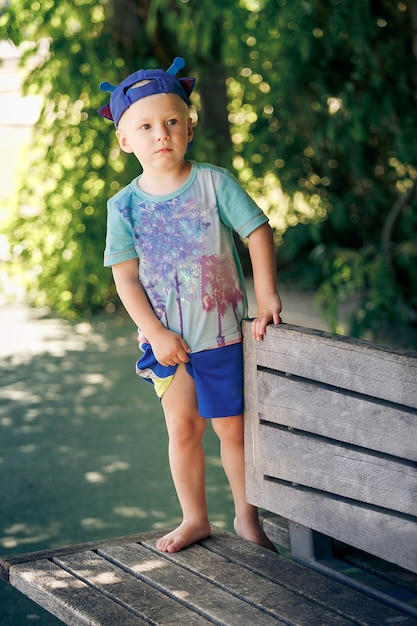 Full Length Of Boy Standing On Bench At Park