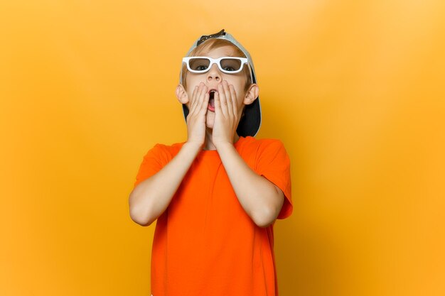 Full length of boy standing on yellow against orange background