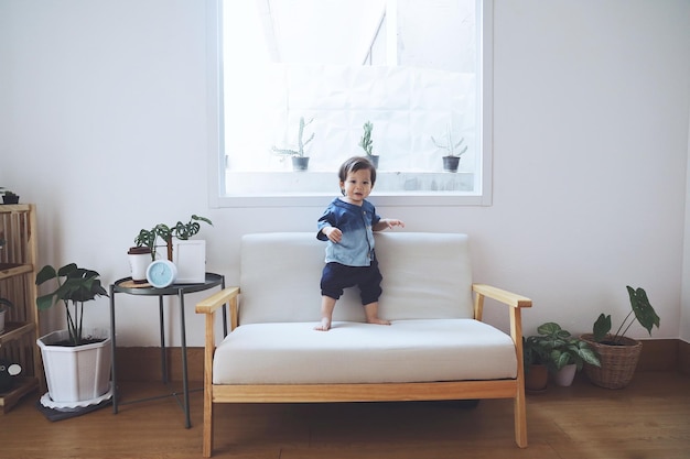 家のテーブルの上の男の子の全長