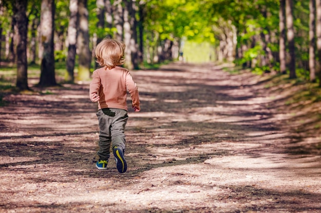 Full length of boy walking on footpath