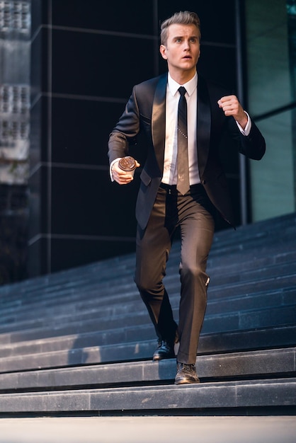 full length of businessman moving down on steps