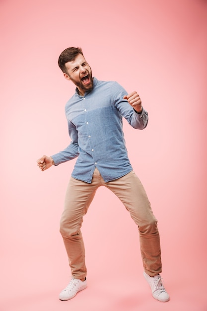 Full length of a cheerful young man standing