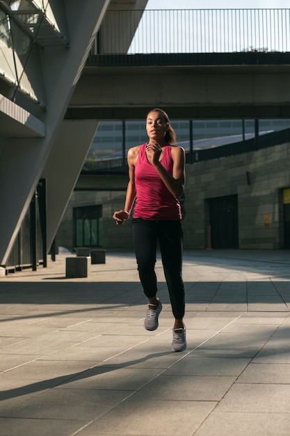 Full length of a confident sportswoman running outdoors alone