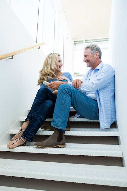 Full length of couple sitting on steps