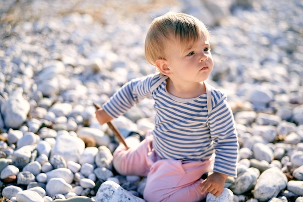 Full length of cute baby boy on rocks