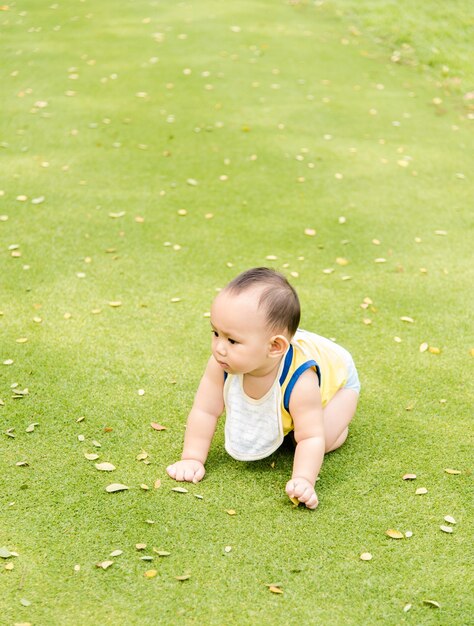 Full length of cute baby girl playing on field at public park