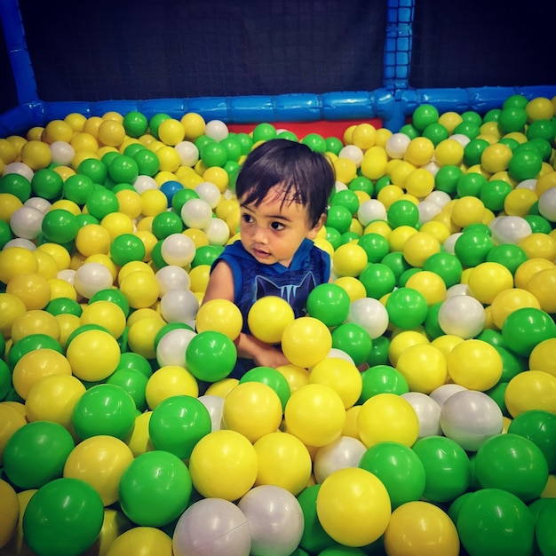 Photo full length of cute boy with ball in balls