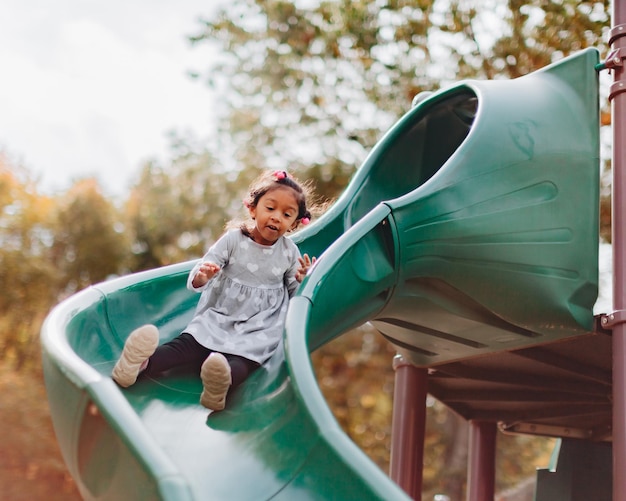 Full length of cute girl on slide at park
