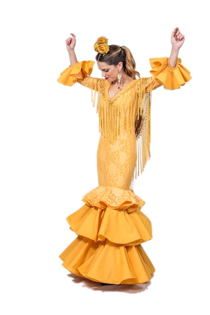 Full length of female dancer in orange costume dancing against white background