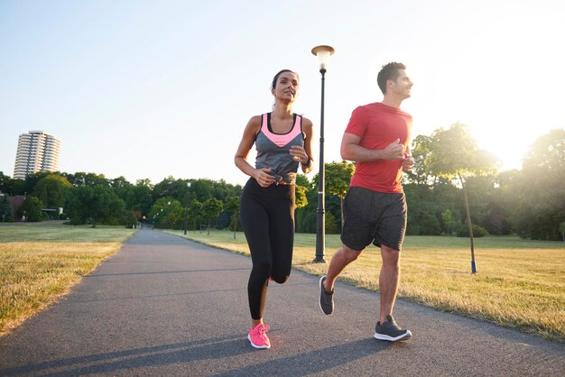 Full length of friends jogging at park