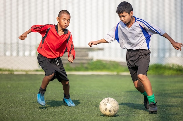 Full length of friends playing on soccer field