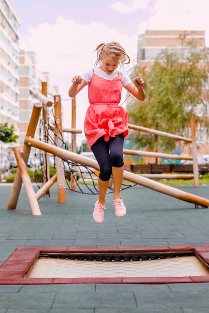 full length of girl jumping on trampoline