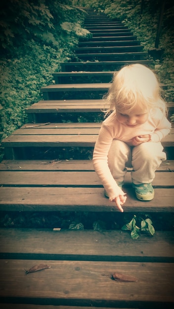 Photo full length of girl pointing at slug on steps