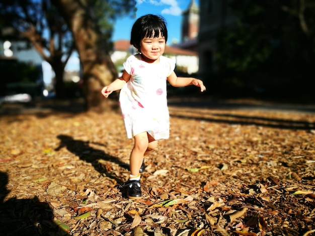 Full length of girl running on field