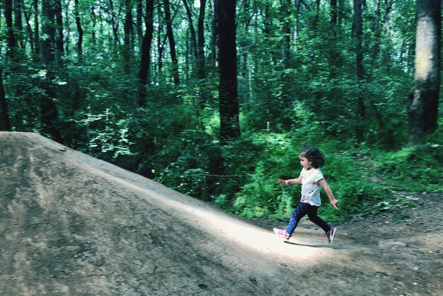 Photo full length of girl running in forest