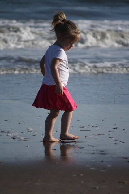 Photo full length of girl standing at beach