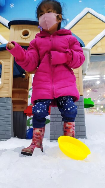 Full length of girl with snow during winter