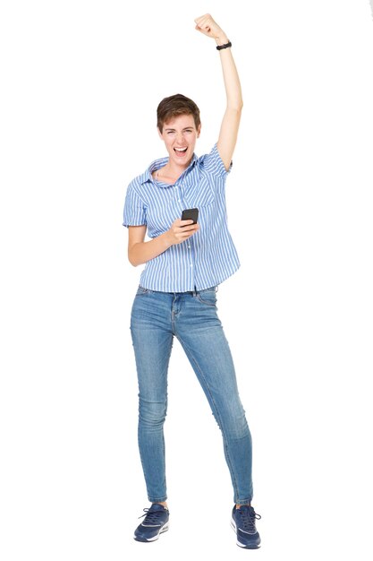 Full length happy young woman with cellphone cheering