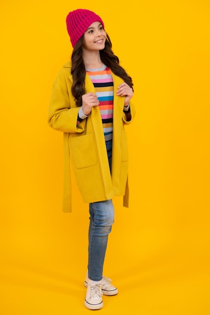 Full length of her she attractive pretty lovely cute cheerful cheery teenager child girl isolated over vivid yellow background happy teenager positive and smiling emotions of teen girl