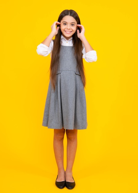 Full length of her she attractive pretty lovely cute cheerful cheery teenager child girl isolated over vivid yellow background
