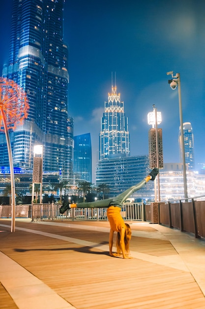 Full length of illuminated buildings in city against sky at night