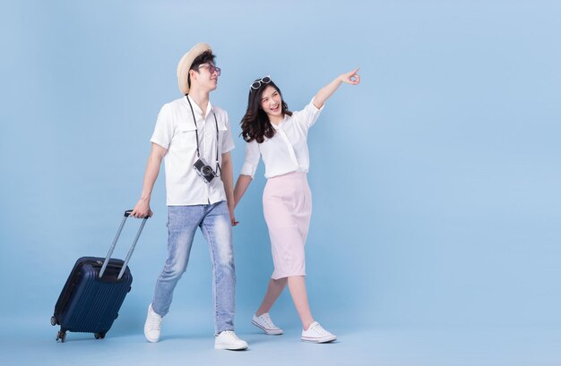 Photo full length image of young asian couple travel summer vacation