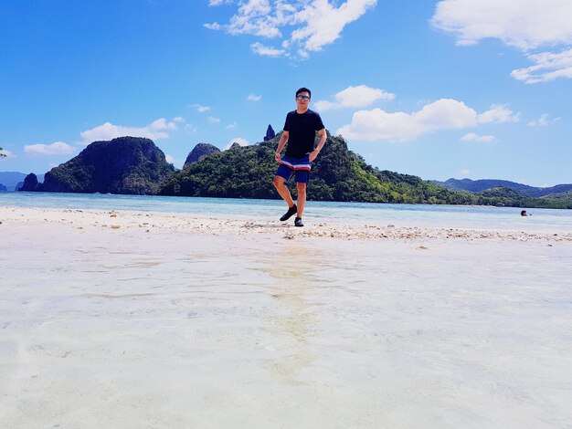 Full length of man on beach against sky