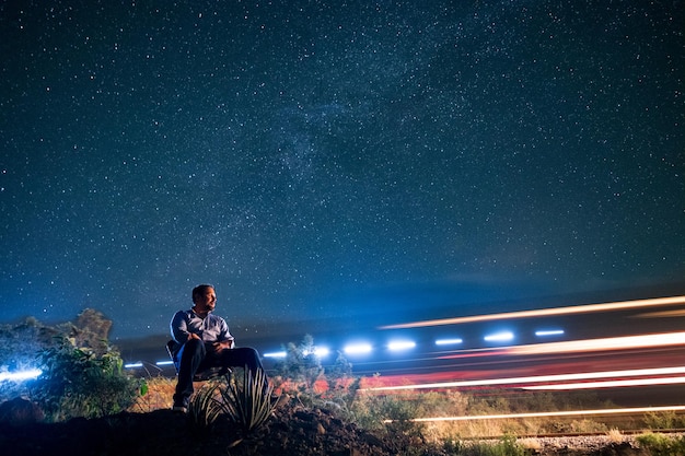 Photo full length of man by light trails at night