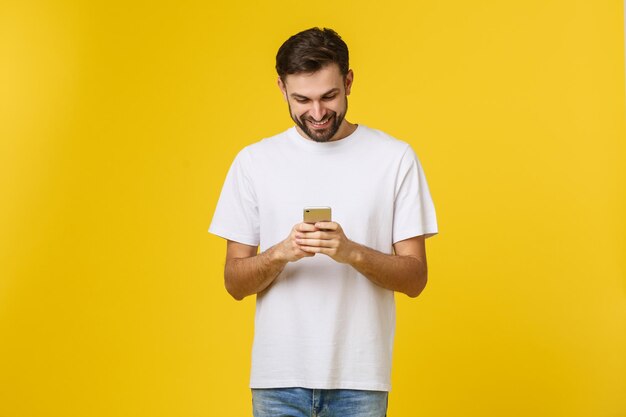 Full length of a man drinking glass against yellow background