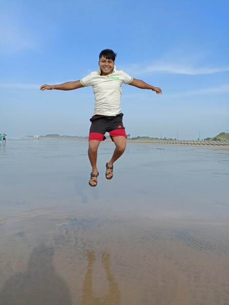 Full length of man jumping on beach