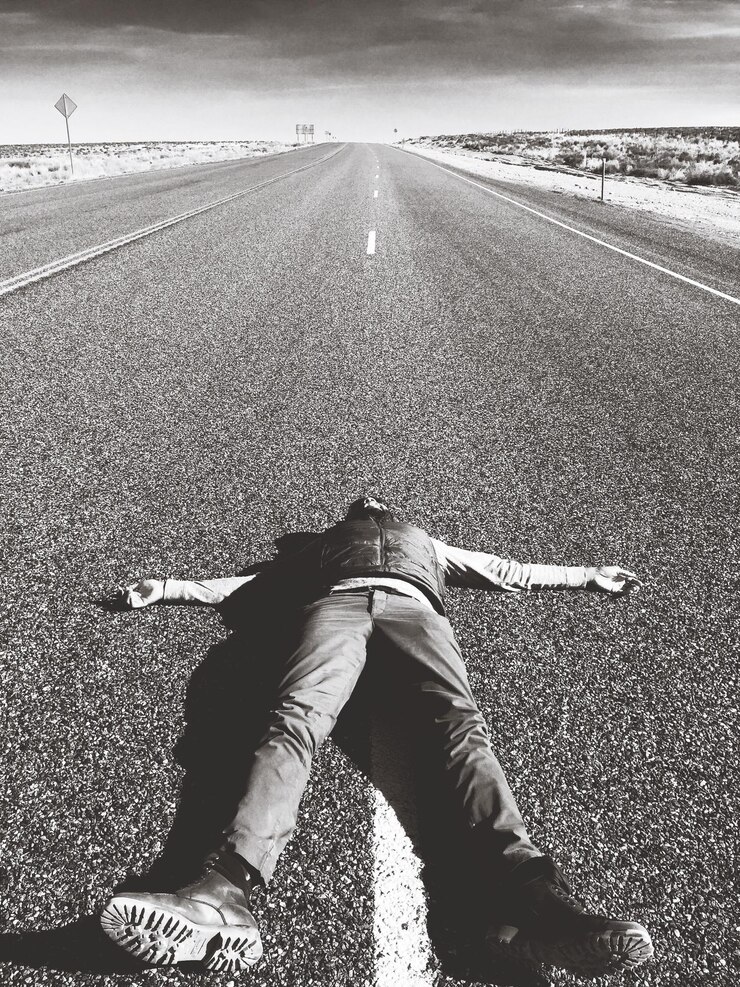 Photo 晴れた日に道路に横たわっている男の全長