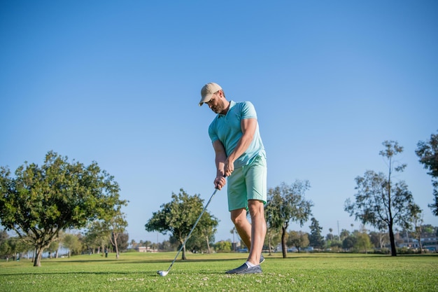 Full length man playing golf game on green grass, sport.