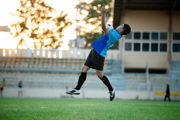 Photo full length of man playing soccer on field