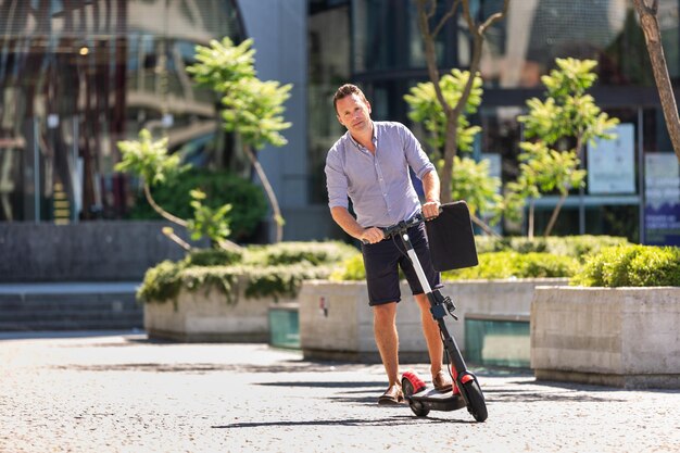 Photo full length of man on push scooter in baby