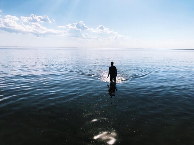 Full length of man in sea against sky