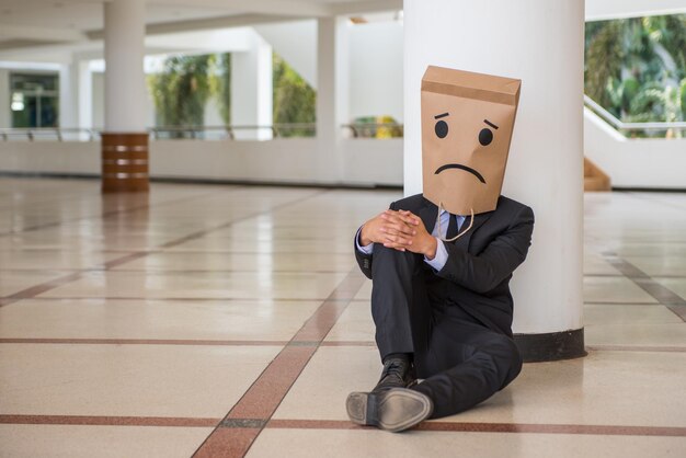 Photo full length of a man sitting on floor