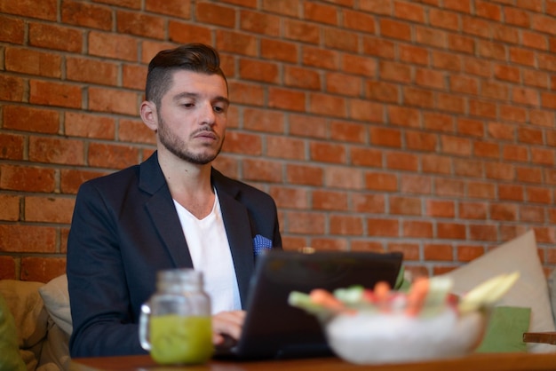 Full length of a man sitting in restaurant