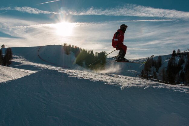 Full length of man on snowcapped mountains against sky during winter