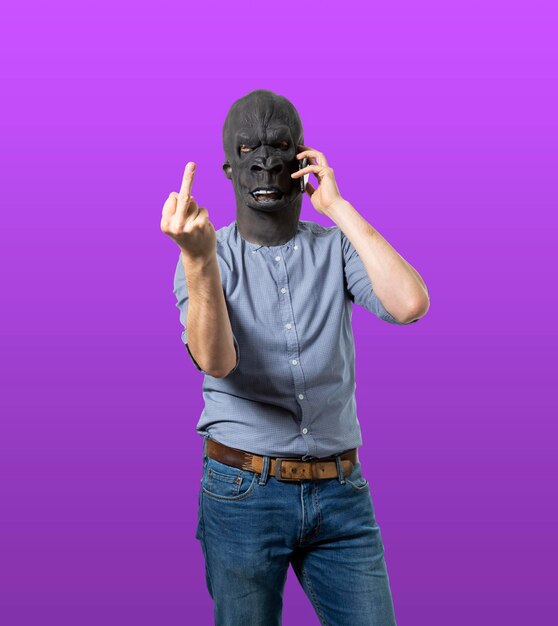 Full length of man standing against purple colored background