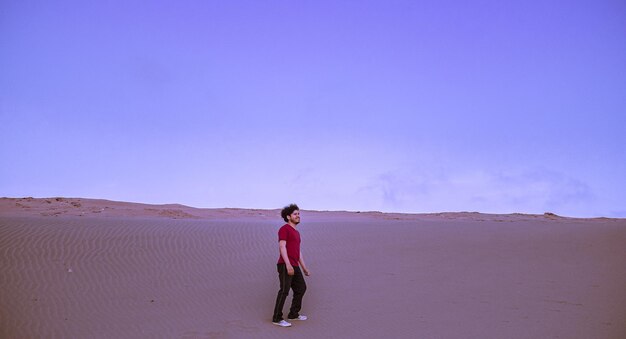 Full length of man standing on arid landscape