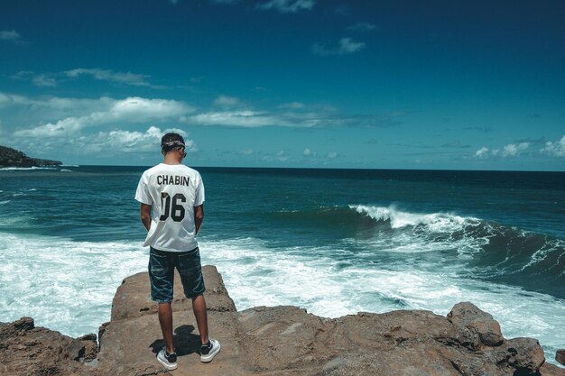 Full length of man standing on beach against sky