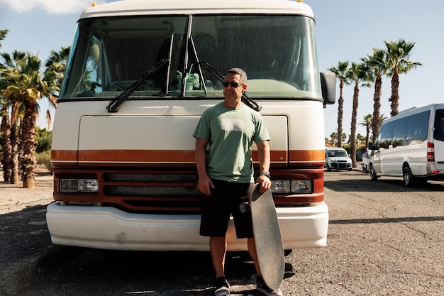 Photo full length of man standing by camper van