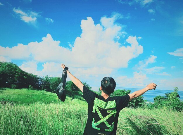 Full length of man standing on field against sky