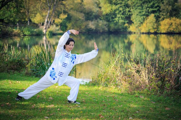 Full length of man standing on field by lake