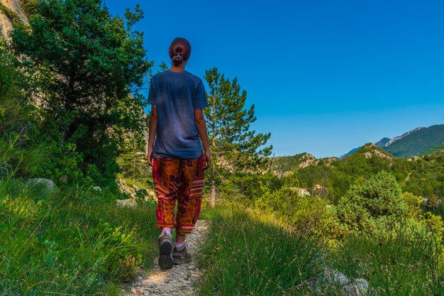 Full length of man standing on mountain against blue sky