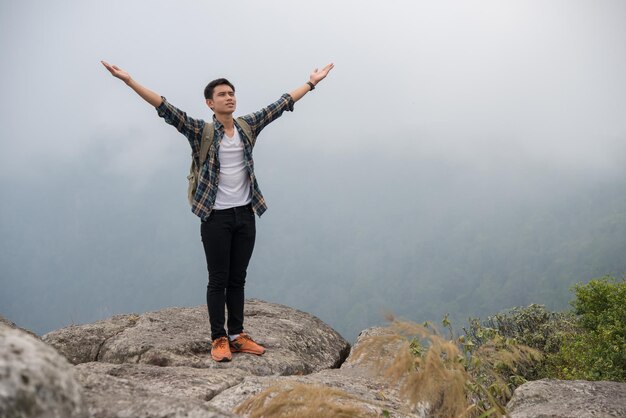 Full length of man standing on rock against mountain