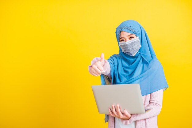 Full length of man using mobile phone against yellow background