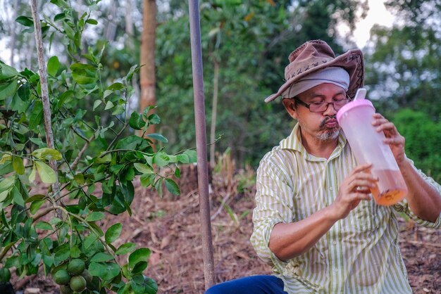 Full length of man wearing hat drinking plants